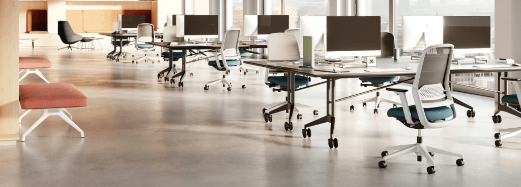 Modern office featuring the ergonomic ME Task Chair in white with blue accents.