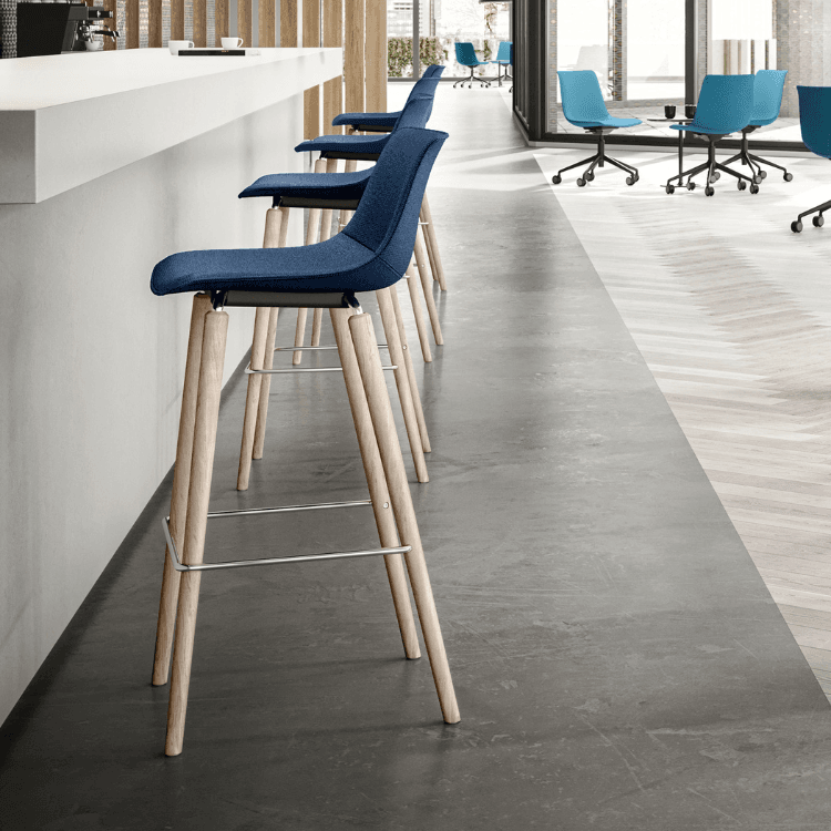 Stylish SHUFFLEis1 Stool by Interstuhl. Blue fabric seat with light wood legs. Modern design for social spaces.