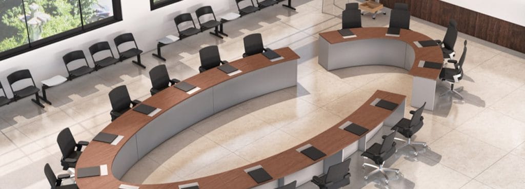 Cosmos Conference room with woodgrain tables and black chairs, aerial view.
