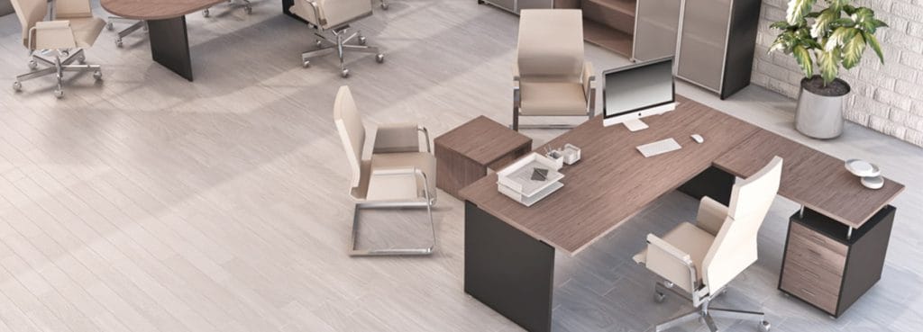 Cosmos Managerial office with wood desk, computer, and cream chairs.