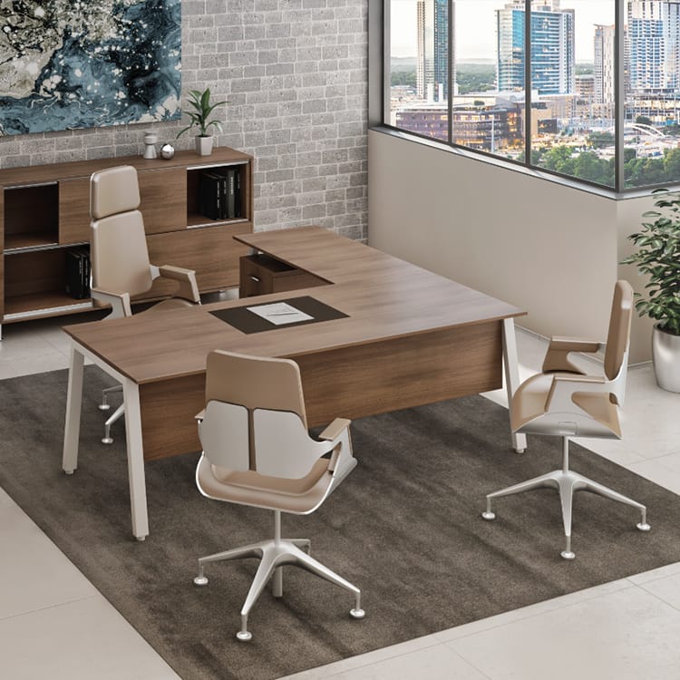 Lamda Managerial office with a spacious wooden desk surrounded by four beige and white swivel chairs atop a soft gray rug. The room features a sleek side cabinet, large city-view window, and striking abstract art displayed on an exposed brick wall. Studio Office Cyprus