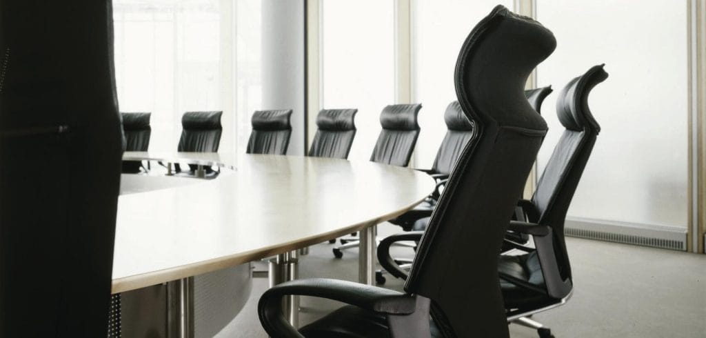 Black Modus Executive chairs around a conference table, offering optimal support and comfort.