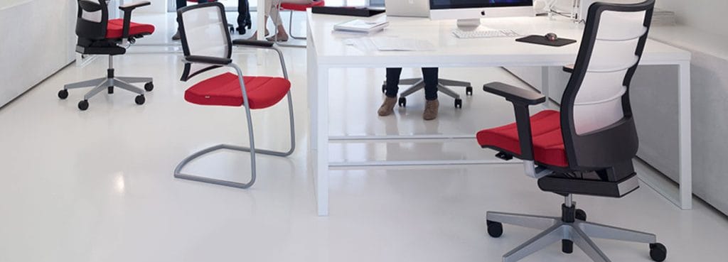 Ergonomic AirPad by Interstuhl: Mesh back swivel chair with red seat, perfect for executive or private office seating.