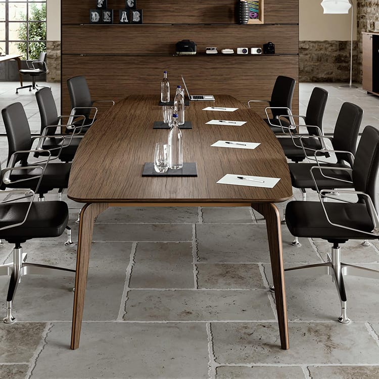 Blade X Executive Meeting Table with wood finish and black leather chairs.