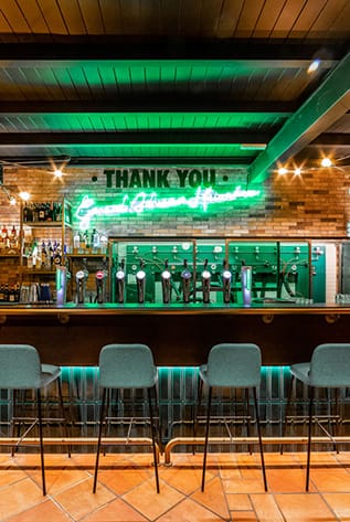 Stylish Bars with green neon lighting, wood and tile. Hospitality furniture.