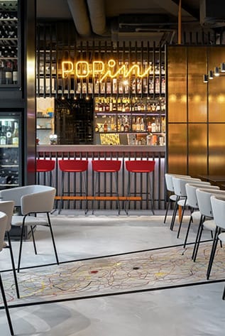 Stylish Bars with red stools and a neon sign. Hospitality furniture for a modern bar.