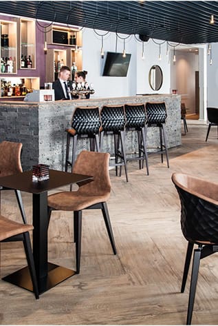 Stylish Bars feature modern seating, concrete counter, and warm lighting. Ideal for hospitality venues.