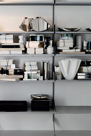 Stylish gray Modular Systems shelving unit with books and decor.