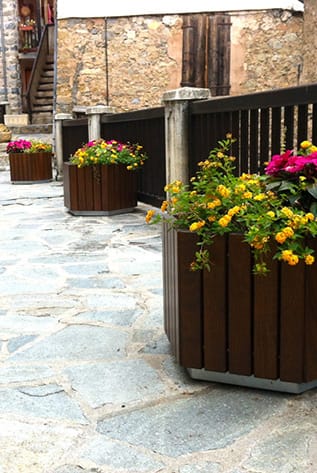 Stylish planters. Brown wood-look, with colorful flowers. Ideal for gardens, patios, or indoor decor.