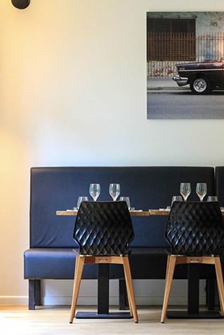 Upscale Restaurants seating with black chairs and booth. Modern design for dining.