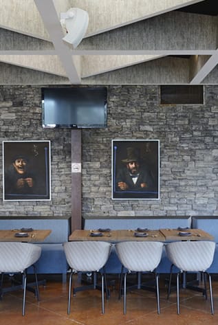 Stylish Restaurants seating with gray chairs and wood tables. Modern design.