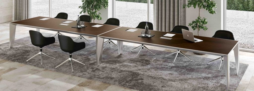 Modern ERACLE Conference Table with a wood top and metal legs, surrounded by black chairs in a bright meeting room.