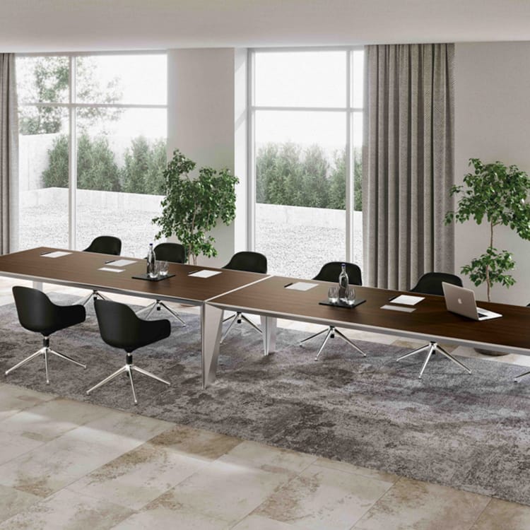 Modern ERACLE Conference Table with brown wood top, silver legs, and black chairs in a bright meeting room.