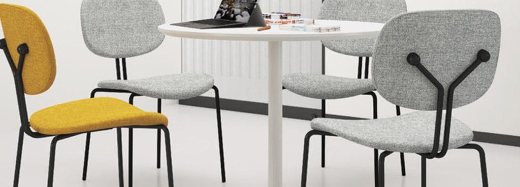 ET chair in yellow and gray around a white table, ergonomic seating for office or studio.