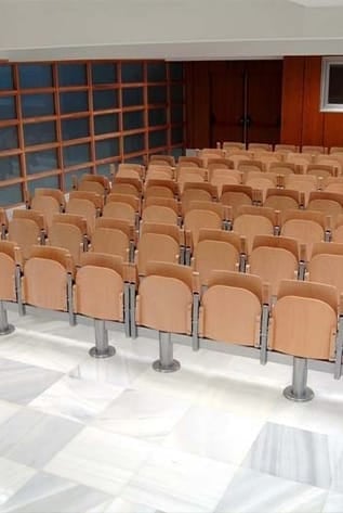 Rows of beige amphitheater seats with metal supports.