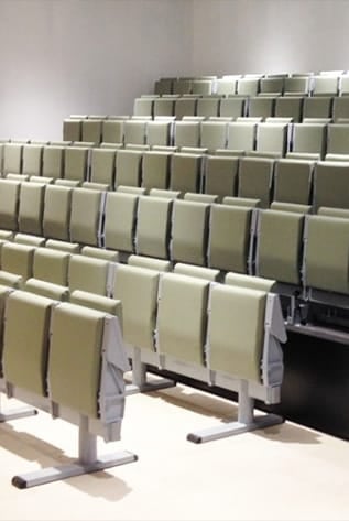 Rows of beige Amphitheater seating with metal frames.