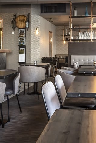 Stylish cafeterias with wooden tables, soft chairs, and ambient lighting for a welcoming dining experience.