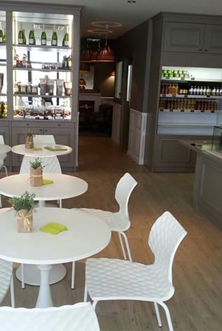 Bright, modern cafeterias with white tables and chairs. Durable furniture solutions.