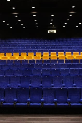 Rows of plush blue and yellow Cinema seating for ultimate comfort.