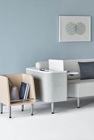 Modern Healthcare Furniture: Light wood storage and gray sofa with integrated table, enhancing patient comfort and organization.