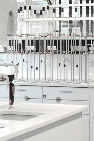 Modern laboratory furniture. White cabinets with scientific glass apparatus.