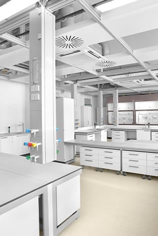 Modern, white Laboratory Furniture with durable countertops and ample storage.