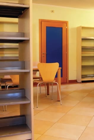 Modern Library Furniture: shelving, table, and chair in a bright, inviting space.