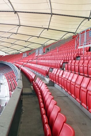 Rows of red stadium seating. Seating and Staging Solutions for venues.