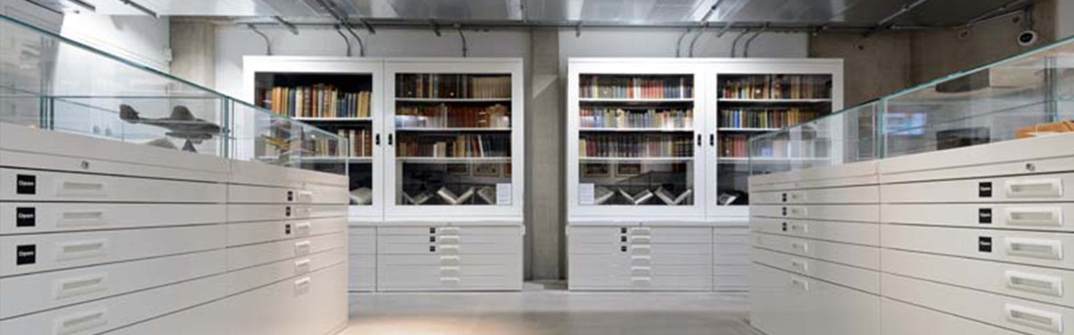 White Museum Storage Solutions with drawers and glass cabinets for artifact preservation.