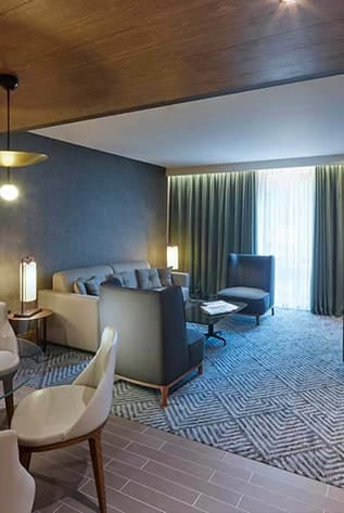 Elegant hotel lounge area with comfortable seating. Hospitality furniture for stylish, relaxing spaces.
