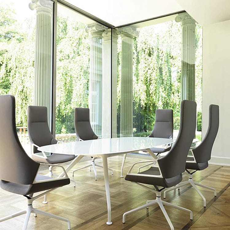 Modern Graph Conference Table with gray chairs in bright room.
