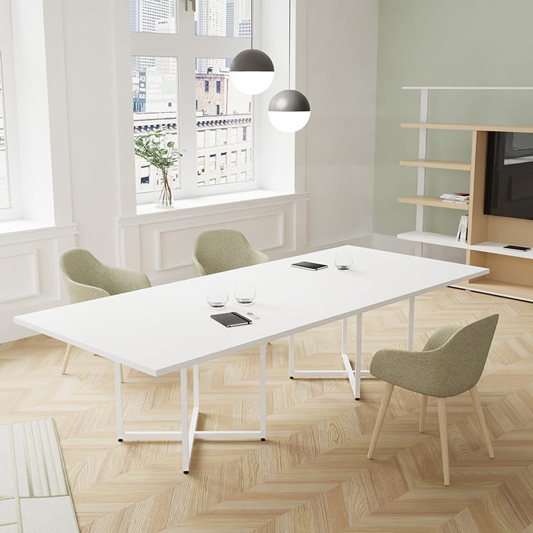 Modern IBIS meeting table with white top and metal frame, surrounded by four light green chairs.