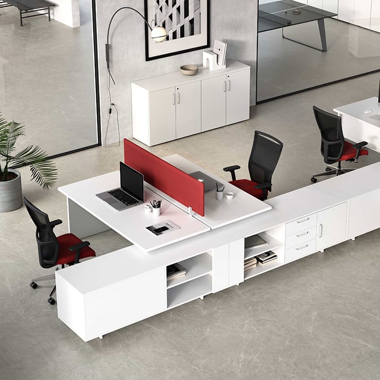 Modern white Kompas workstation with red accents, featuring desks, storage, and ergonomic chairs for an open office space.
