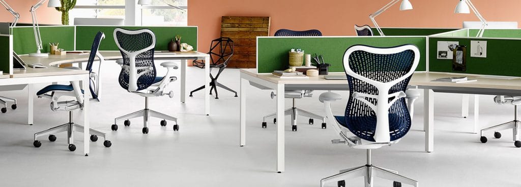 Office space with Mirra 2 chairs. Ergonomic seating with a white frame and blue mesh back.