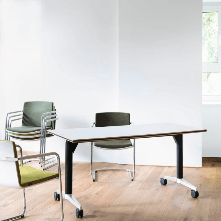 Minimalist conference room with Neos chairs, a white table, and wooden floor.