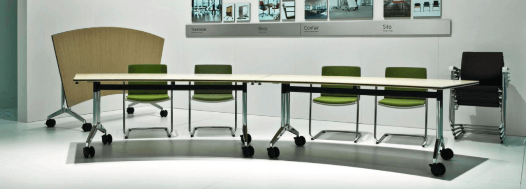 Modern conference room featuring a long table with green Neos chairs and a wooden partition.