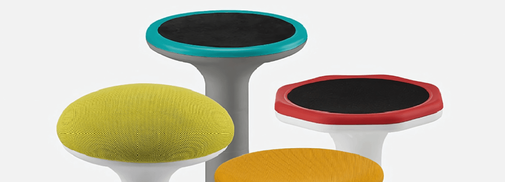 Mogoo Stool for active seating. Colorful studio office stools in yellow, orange, red, and blue.