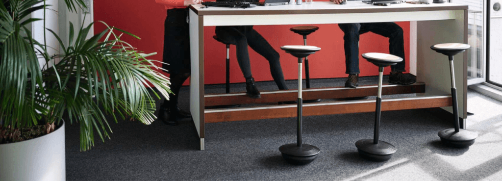 Active office: Stitz 2 perching stools at a standing desk, promoting dynamic, healthy posture.