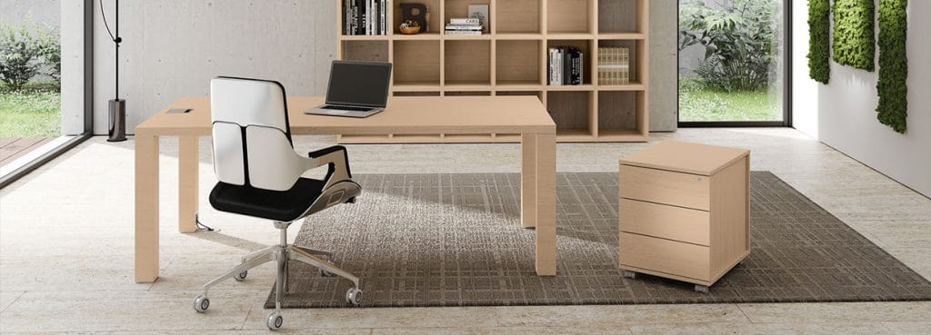 Modern office setup with ODEON desk, chair, and filing cabinet. Light wood finish.