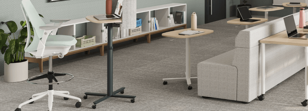 Modern office featuring a light green Sayl Stool, ergonomic design for collaborative workspaces.