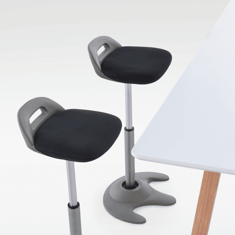 Two gray Lotus Stools with black seats next to a white table.
