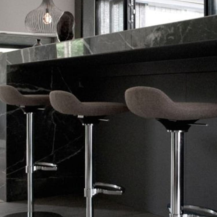 Three LIMEis5 stools with chrome bases and gray seats at a dark marble counter.