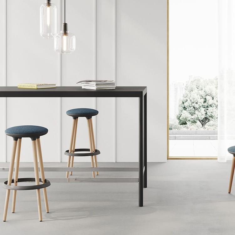 Product Zoom: Modern stools with blue seats and wooden legs at a black table, pendant lights above.