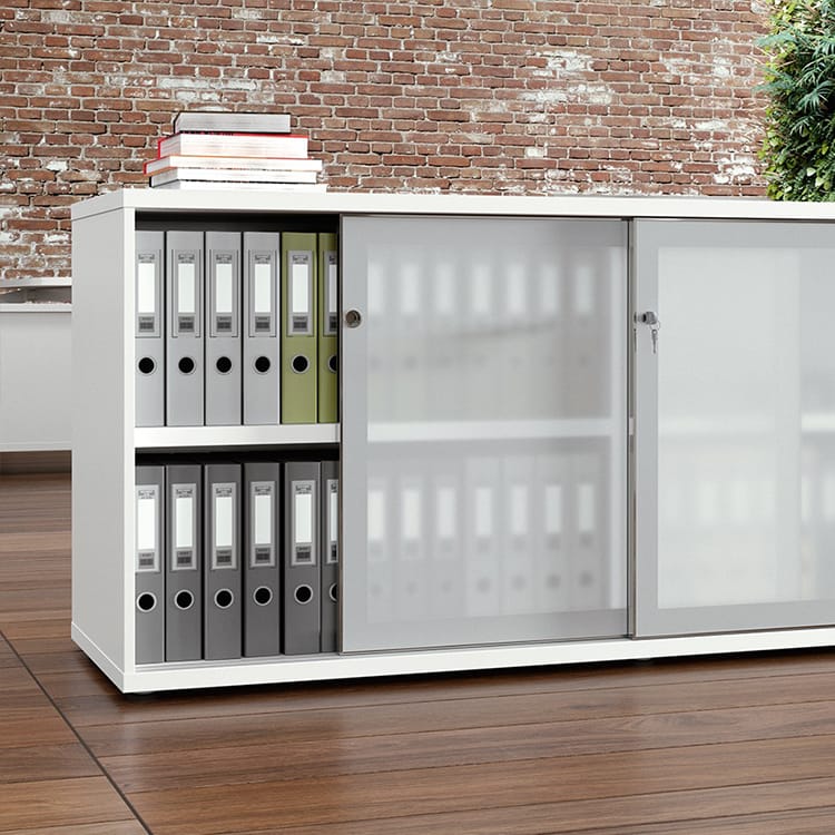 White Romolo Storage System with sliding doors, filled with files, for modern office storage solutions.