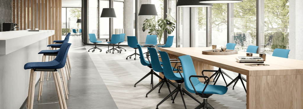 Modern office space with blue SHUFFLEis1 chairs and wooden tables.