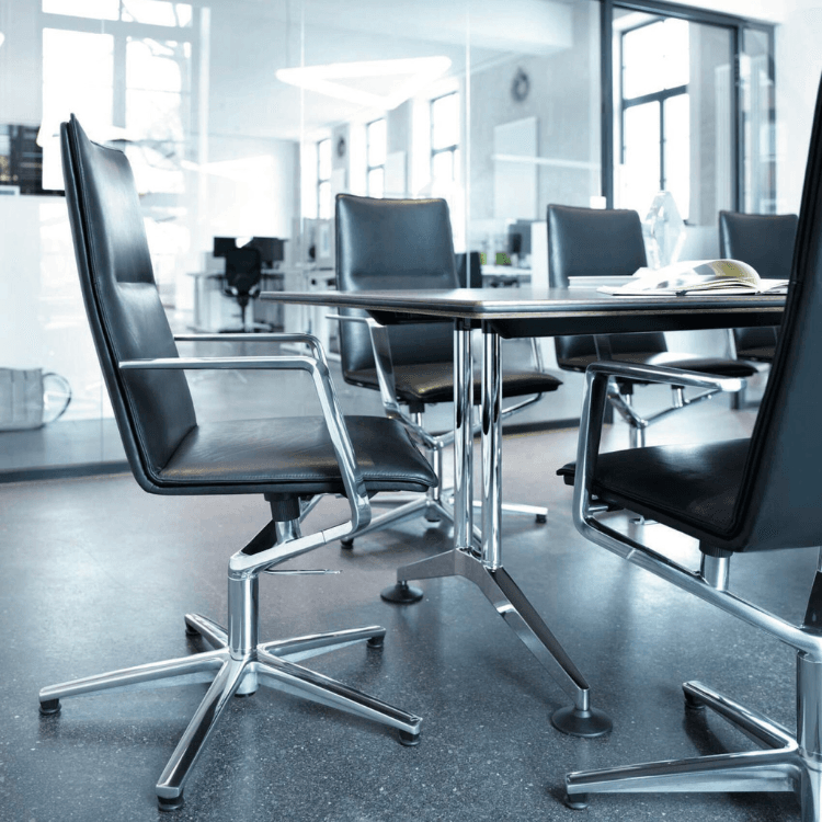 Conference room featuring black leather Sola chairs with chrome frames around a table.