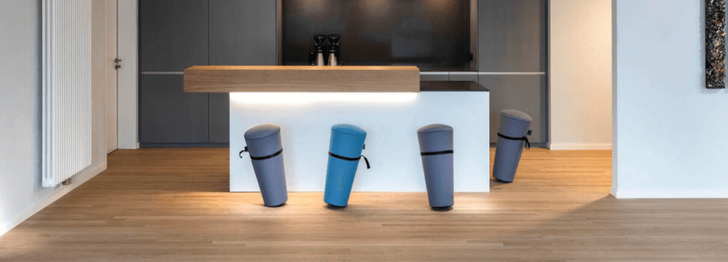 Wilkhahn Stand-Up stools in blue and gray, self-righting design for active seating in a modern space.