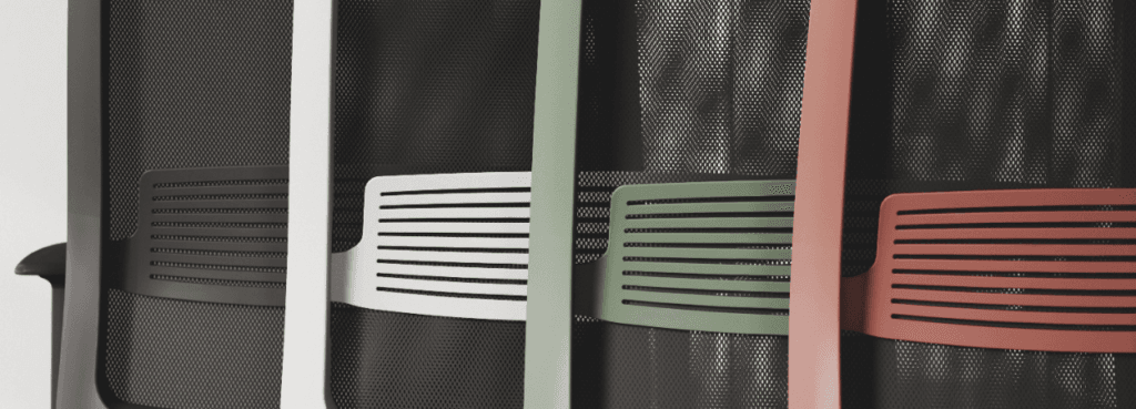 Star chair detail: mesh back, lumbar support in black, white, green, and coral.