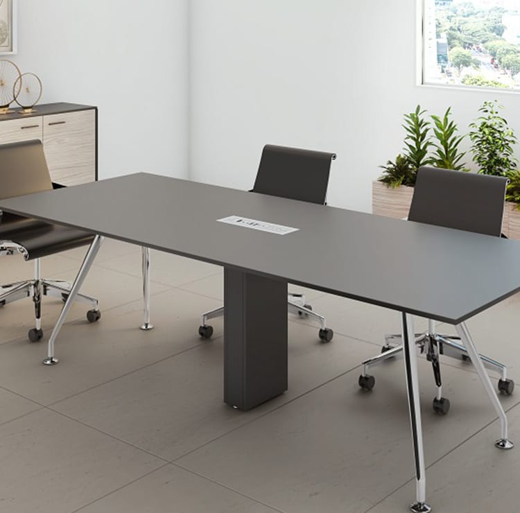 A gray conference table with a cable tower and three chairs.