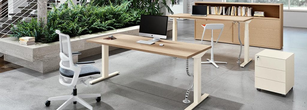 Ergonomic Crono desk system in a modern office setting with light wood and white accents.